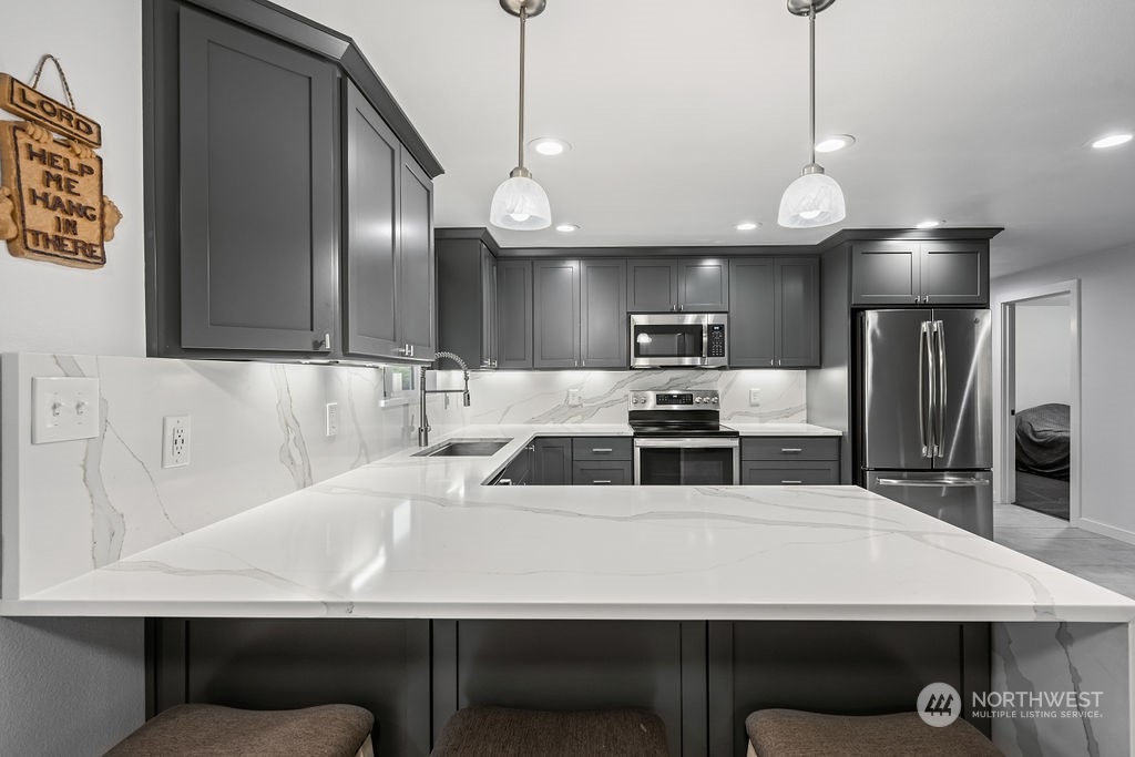 16731 Sargent Road Southwest Rochester, WA 98579 - Photo 12 of 34 a kitchen with counter top space cabinets and stainless steel appliances