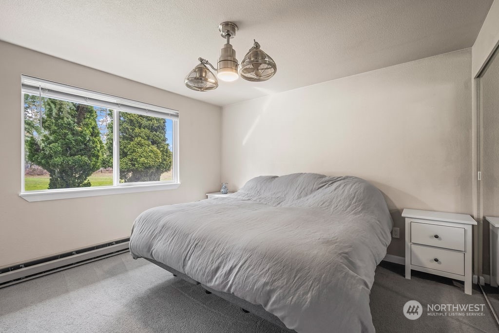16731 Sargent Road Southwest Rochester, WA 98579 - Photo 17 of 34 a large bed sitting in a bedroom next to a window