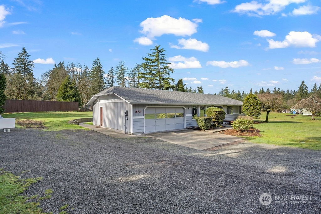 16731 Sargent Road Southwest Rochester, WA 98579 - Photo 22 of 34 a view of a house with outdoor space and a car park in front of the house