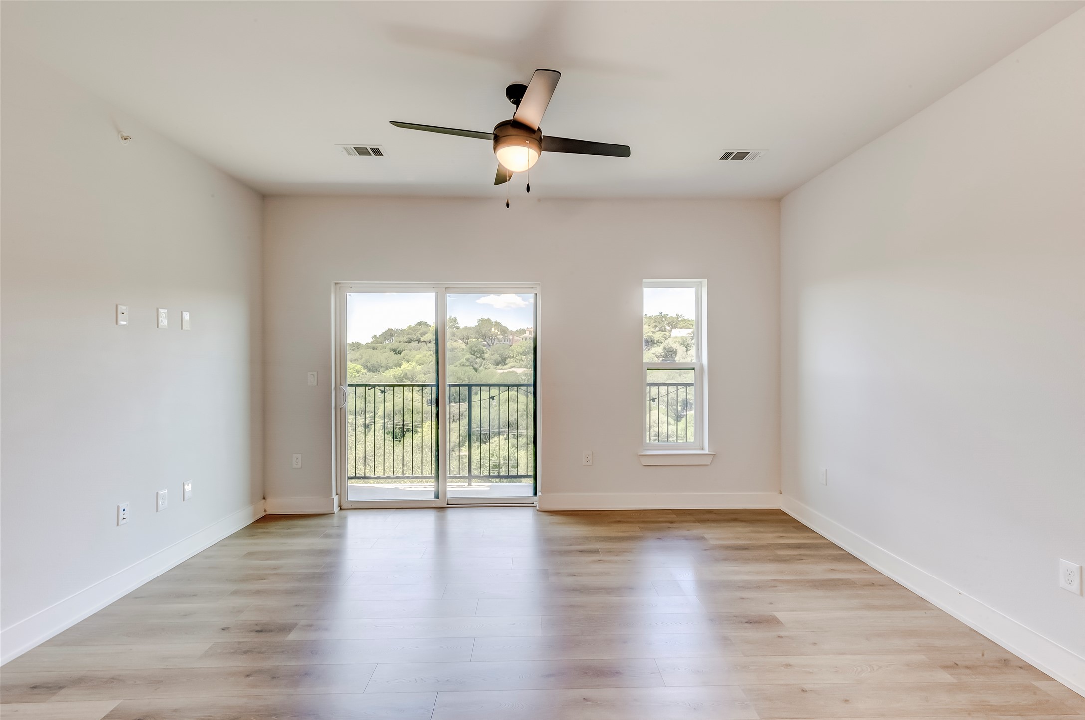 2500 Longview Street, Unit 402 Austin, TX 78705 - Photo 3 of 27 an empty room with wooden floor and windows