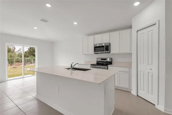 a kitchen with stainless steel appliances a refrigerator sink and stove