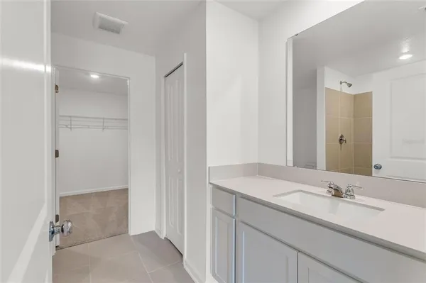 a bathroom with a sink and mirror