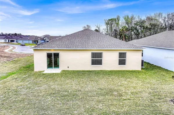 a view of a house with a yard and plants