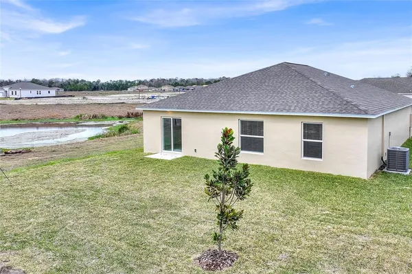an aerial view of residential houses with outdoor space and parking