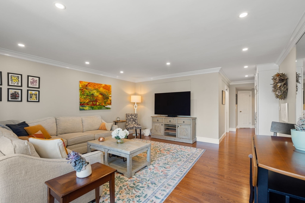 85 East India Row, Unit 20G Boston, MA 02110 - Photo 12 of 37 a living room with furniture and a flat screen tv