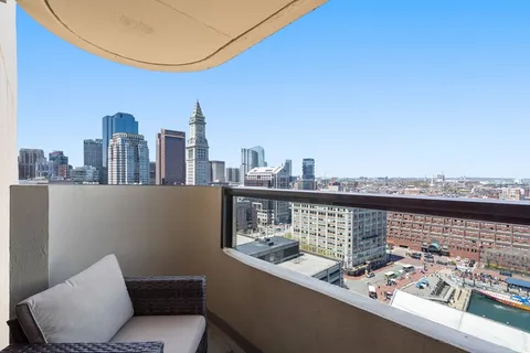 a view of roof deck with two chairs and a table