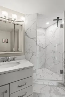 a bathroom with a sink a mirror and shower