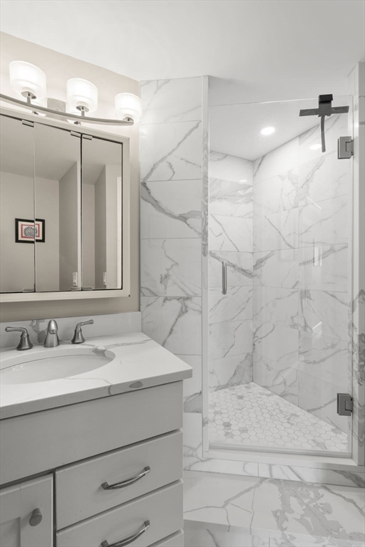 85 East India Row, Unit 20G Boston, MA 02110 - Photo 18 of 37 a bathroom with a sink a mirror and shower