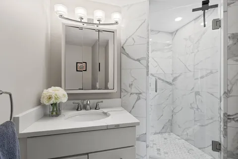 a bathroom with a sink mirror and vanity