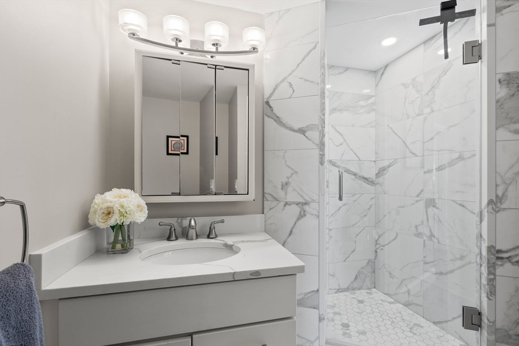 85 East India Row, Unit 20G Boston, MA 02110 - Photo 19 of 37 a bathroom with a sink mirror and vanity