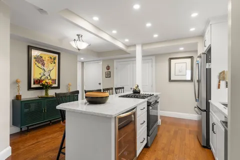 a kitchen that has a sink a stove and a table