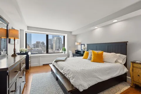 a bedroom with a large bed and a large window