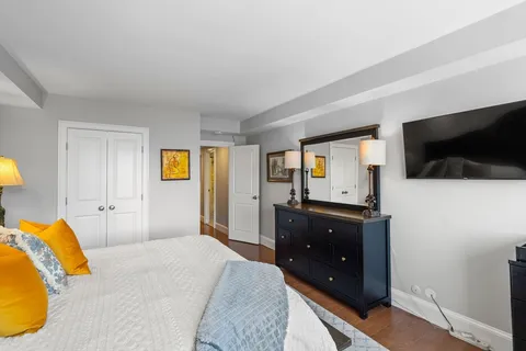 a bedroom with a bed and flat screen tv