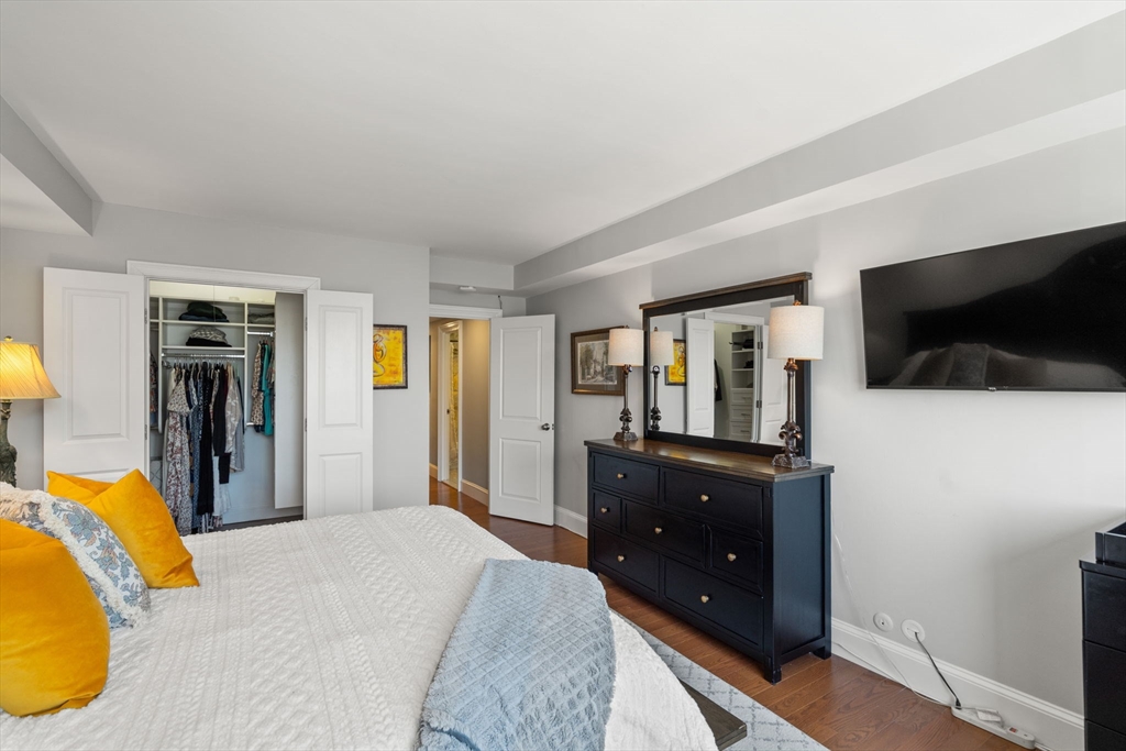 85 East India Row, Unit 20G Boston, MA 02110 - Photo 24 of 37 a bedroom with a bed and a television
