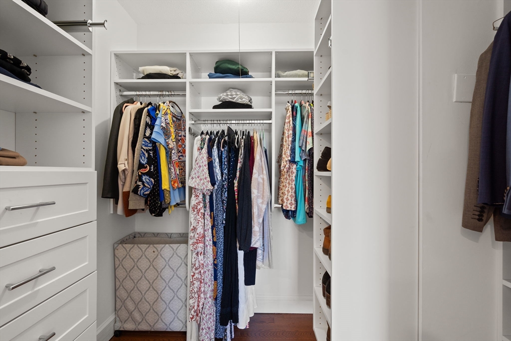 85 East India Row, Unit 20G Boston, MA 02110 - Photo 25 of 37 a view of walk in closet with clothes and shoes
