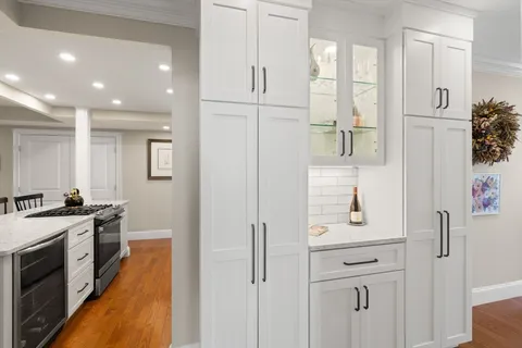 a kitchen with white cabinets and stainless steel appliances