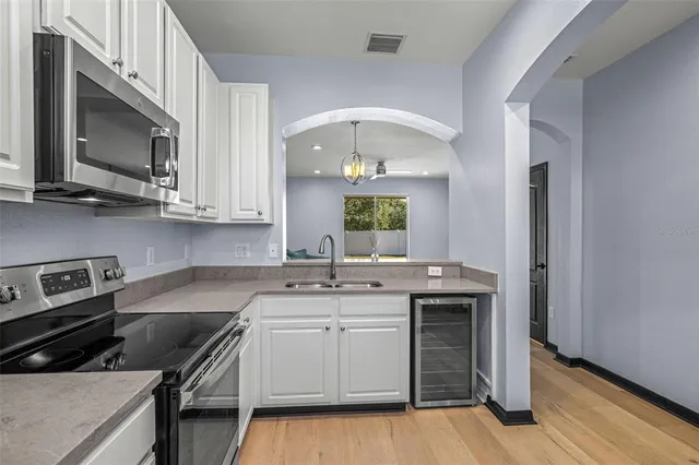 a kitchen with a sink stove and microwave