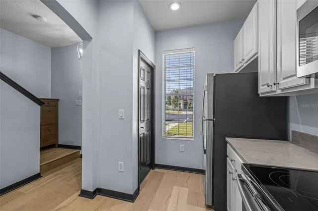 a kitchen with stainless steel appliances granite countertop a refrigerator and a sink