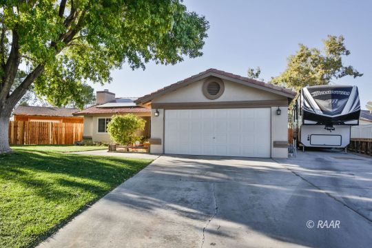 424 Mavis Court Ridgecrest, CA 93555 - Photo 3 of 32 a front view of a house with a yard and garage