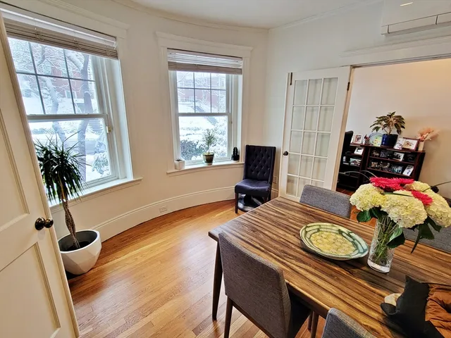 a view of a workspace with furniture window and wooden floor