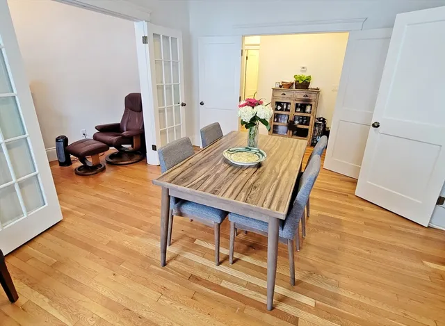 a view of a dining room with furniture and a window
