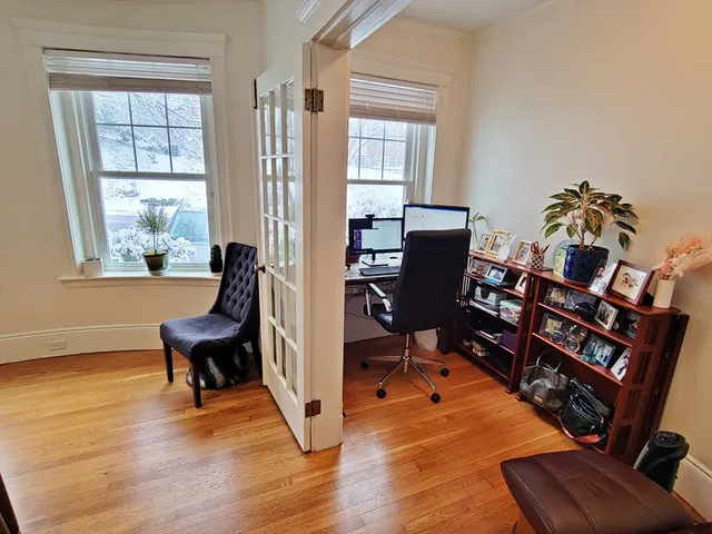 a view of a livingroom with workspace and a window
