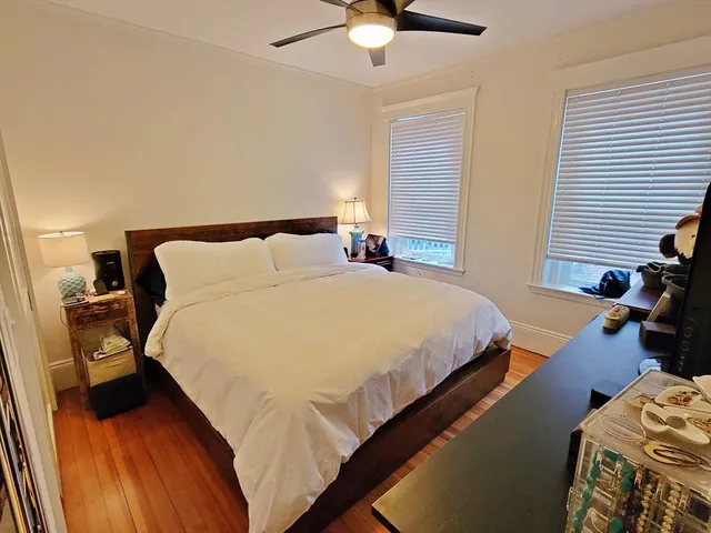 a bedroom with bed and a chandelier
