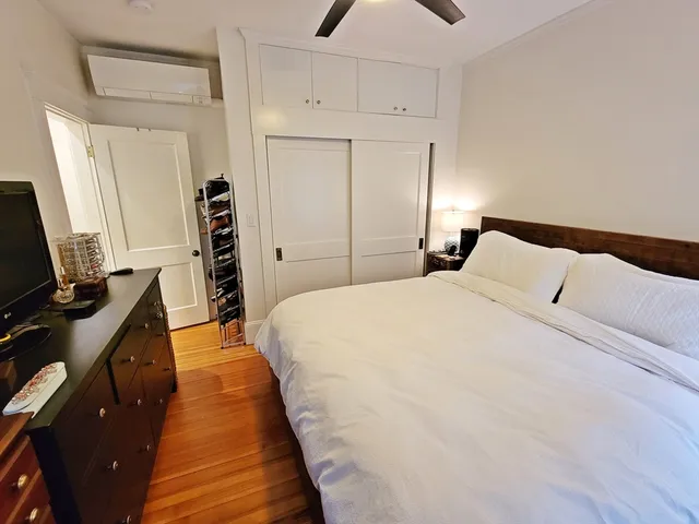 a bed room with a bed and a television