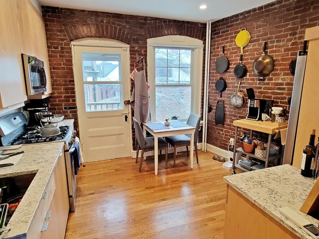 a dining room with furniture and wooden floor