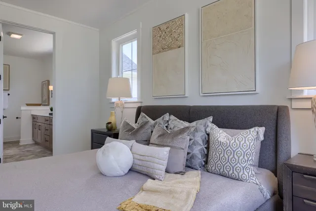 a kitchen with stainless steel appliances a dining table chairs a sink and a refrigerator