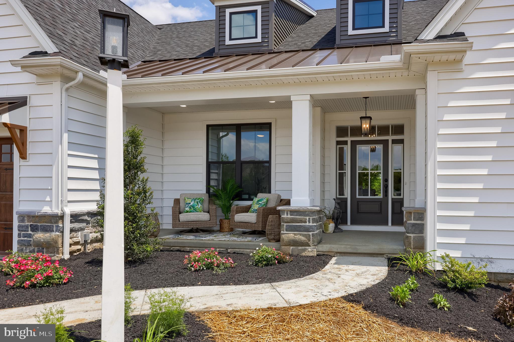 136 Stillcreek Road Millersville, PA 17551 - Photo 3 of 72 a front view of a house with outdoor seating and flowers