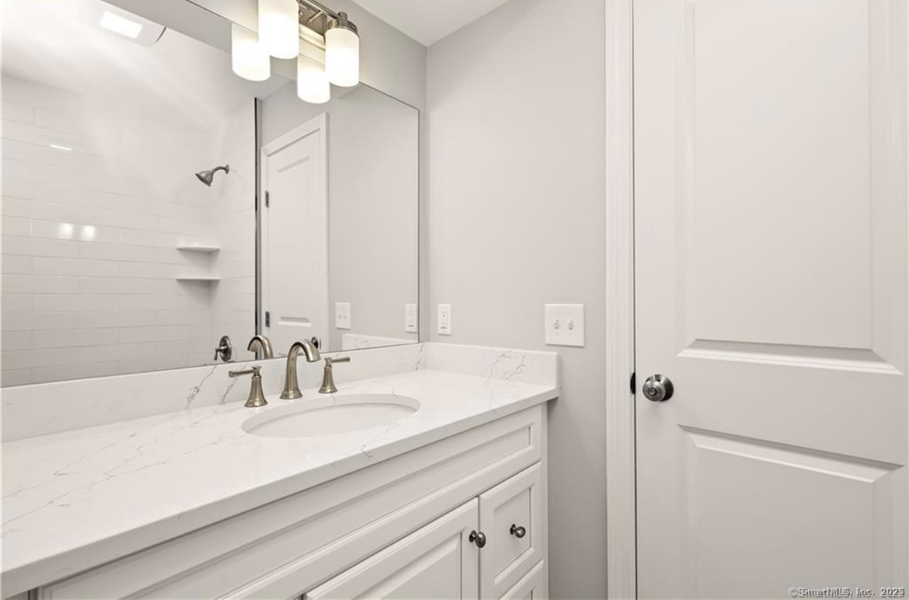 383 Sequoia Lane, Unit A Stratford, CT 06614 - Photo 11 of 17 a bathroom with a sink and a mirror