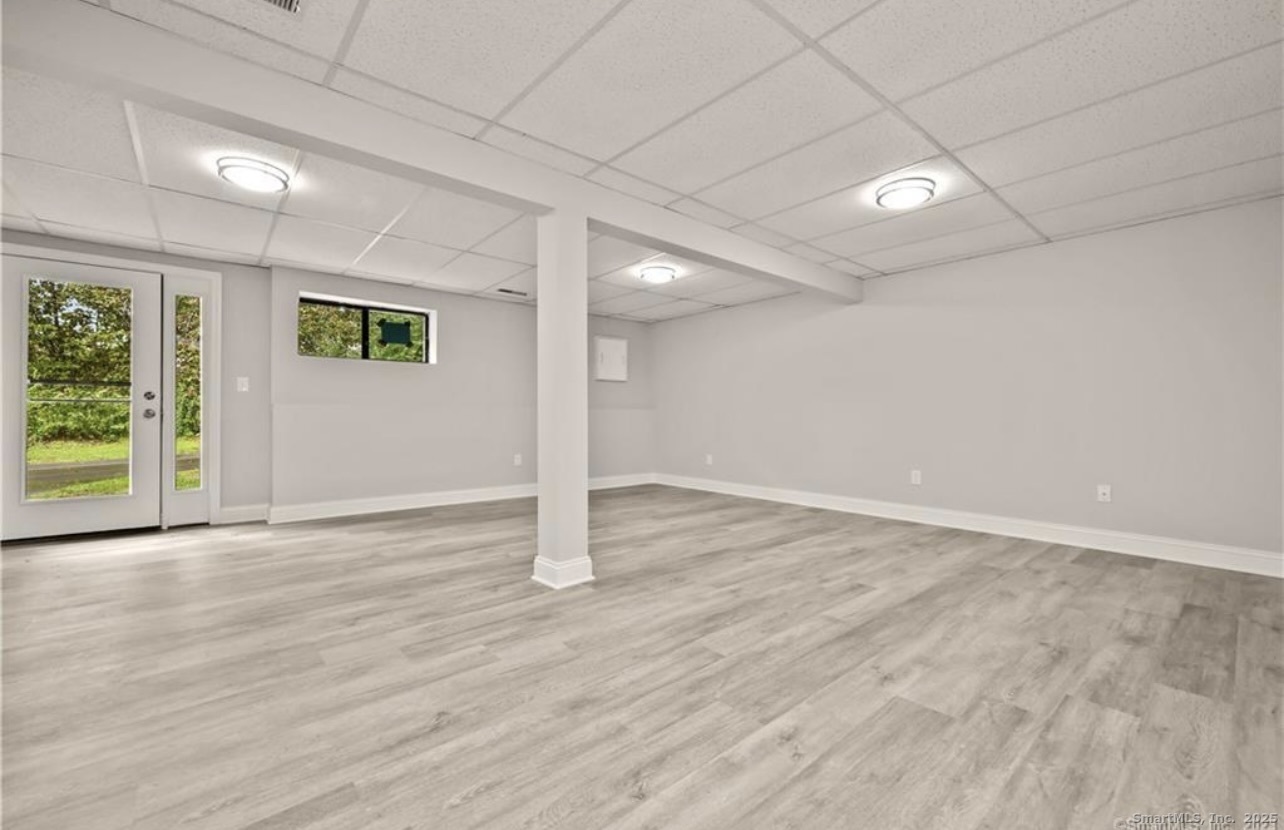 383 Sequoia Lane, Unit A Stratford, CT 06614 - Photo 13 of 17 an empty room with wooden floor and windows