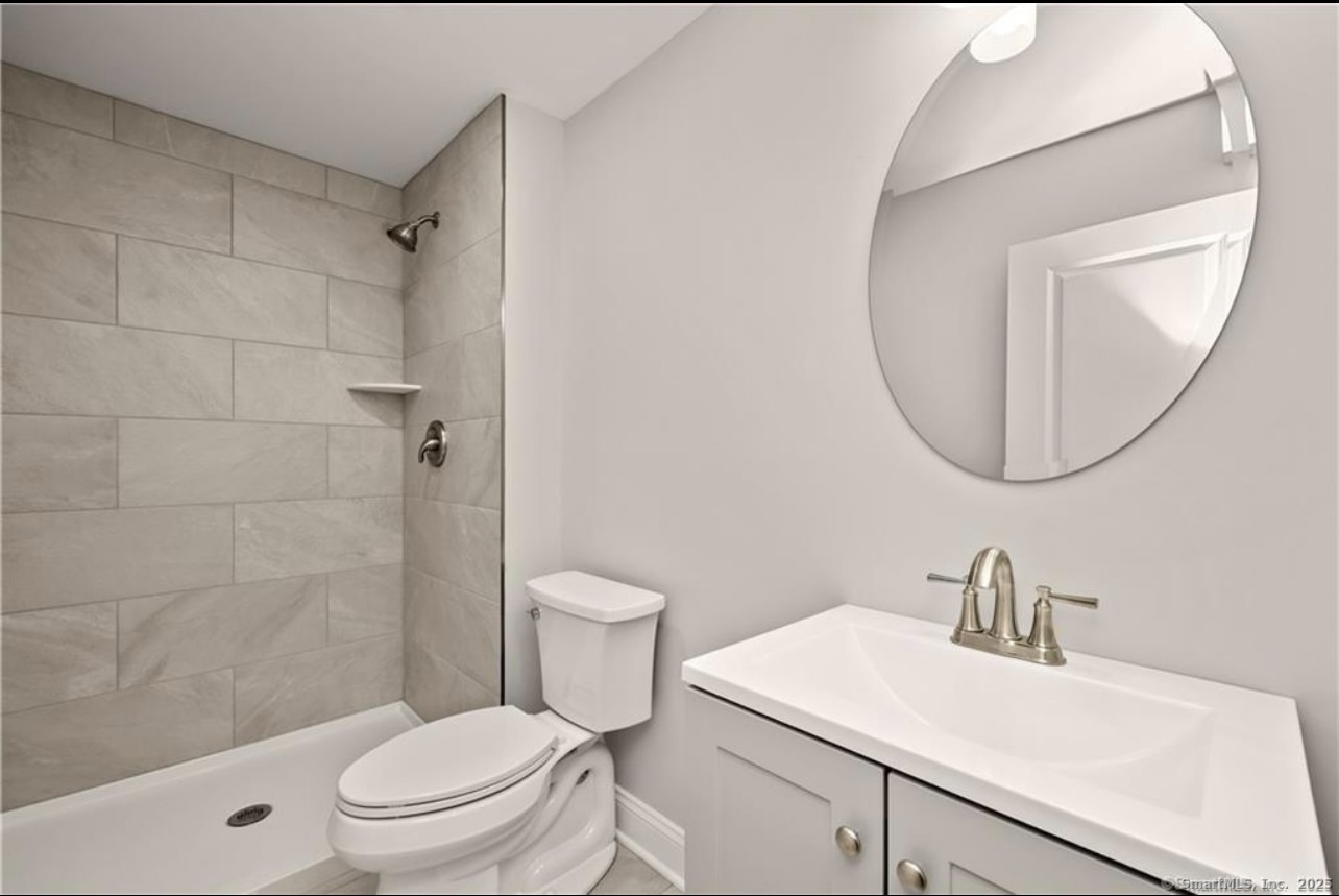 383 Sequoia Lane, Unit A Stratford, CT 06614 - Photo 15 of 17 a white toilet sitting next to a bathroom sink