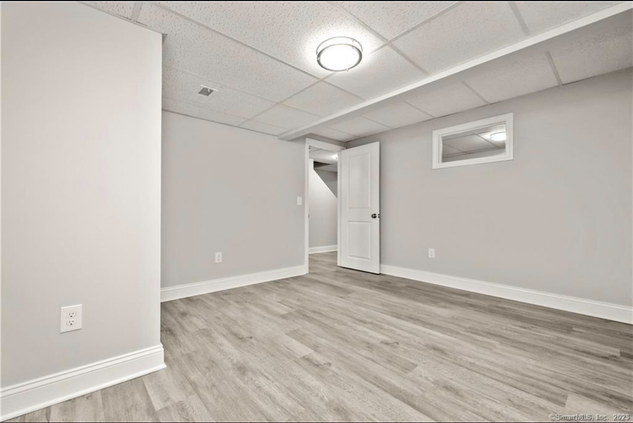 383 Sequoia Lane, Unit A Stratford, CT 06614 - Photo 17 of 17 an empty room with wooden floor and windows