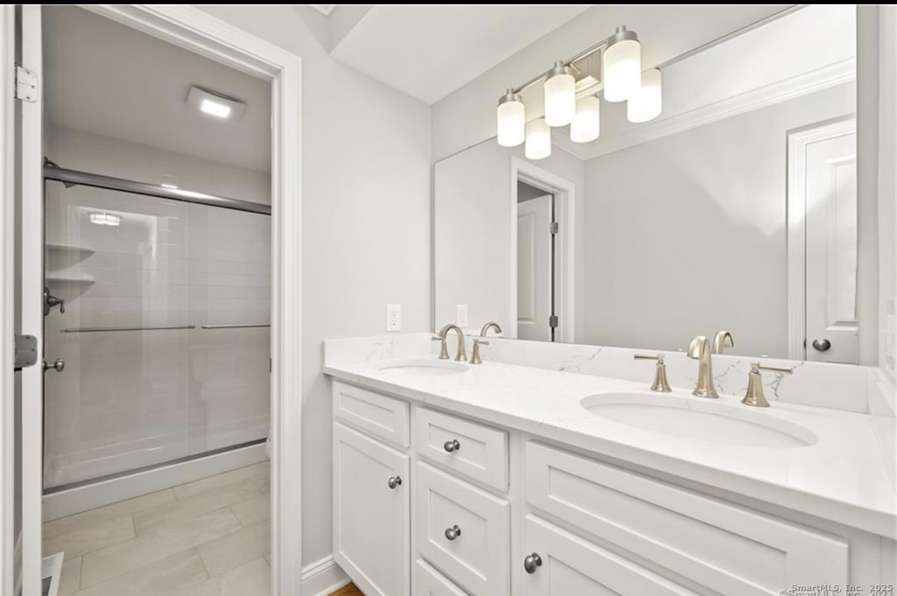 383 Sequoia Lane, Unit A Stratford, CT 06614 - Photo 3 of 17 a bathroom with a double vanity sink and a mirror