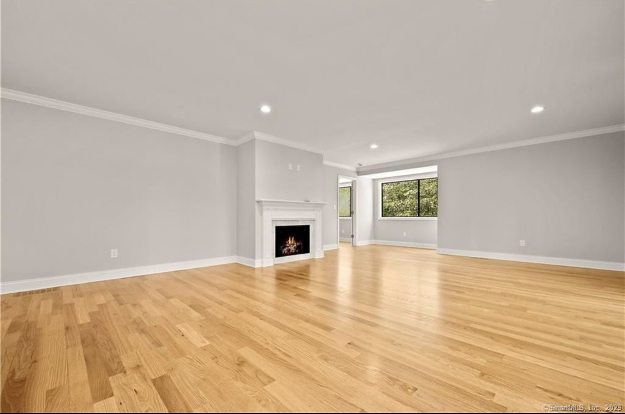 383 Sequoia Lane, Unit A Stratford, CT 06614 - Photo 6 of 17 a view of empty room with wooden floor and fireplace