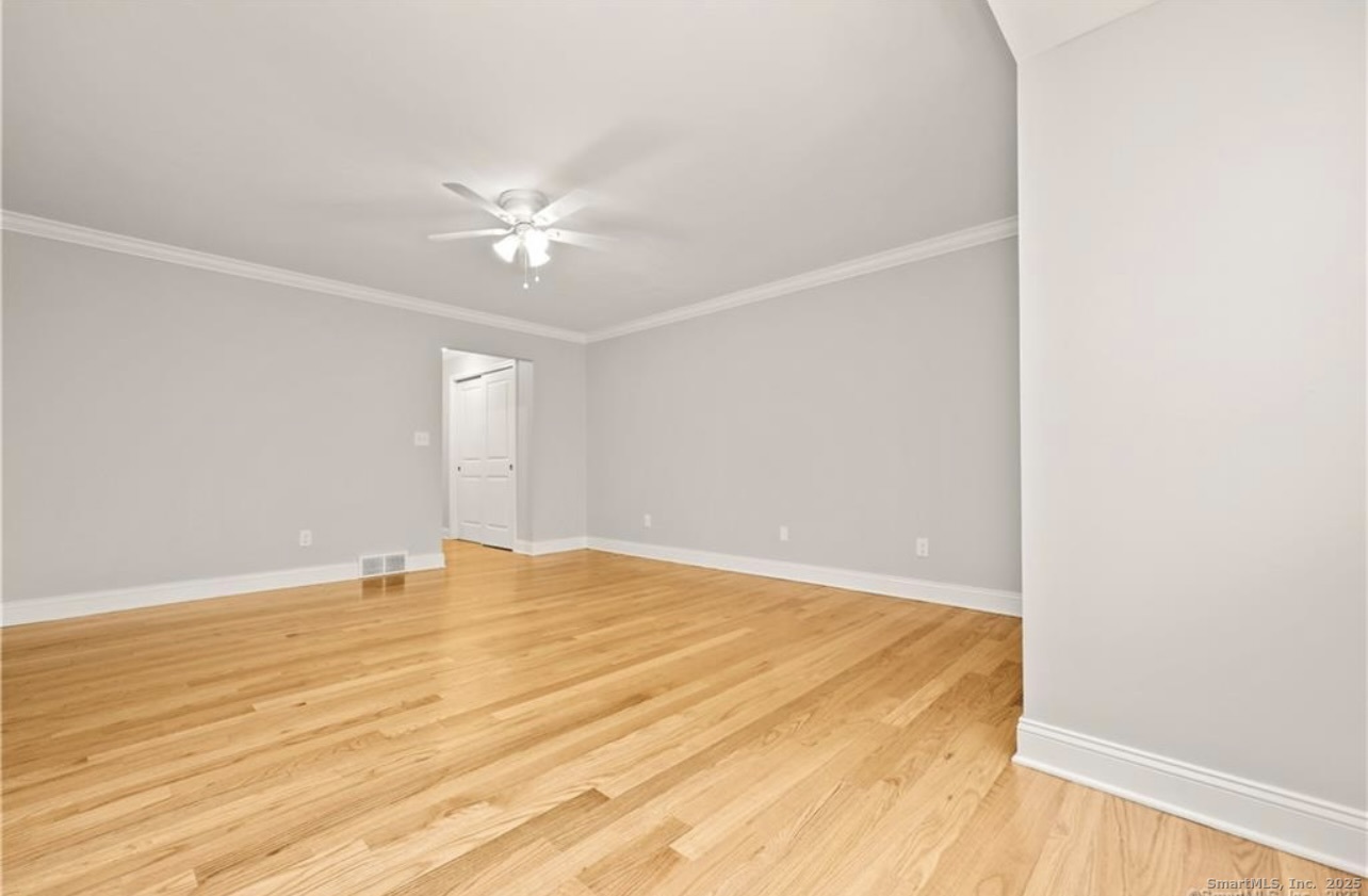 383 Sequoia Lane, Unit A Stratford, CT 06614 - Photo 8 of 17 a view of an empty room with wooden floor