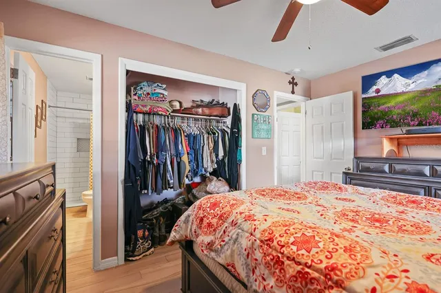 a bed sitting in a bedroom next to a window