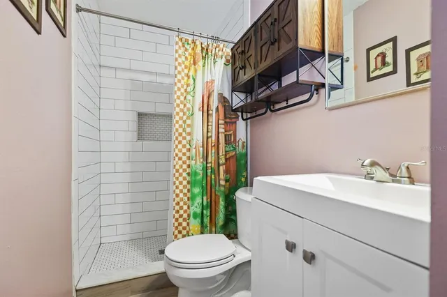 a bathroom with a sink toilet and shower