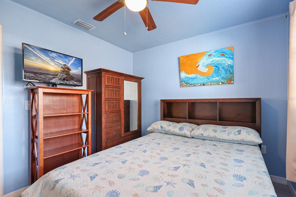 1001 Alpine Drive Brandon, FL 33510 - Photo 16 of 29 a bedroom with a bed and a flat screen tv