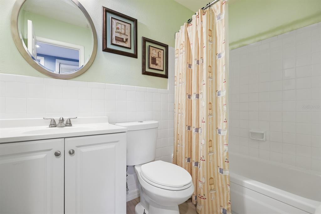 1001 Alpine Drive Brandon, FL 33510 - Photo 17 of 29 a bathroom with a toilet a sink and mirror