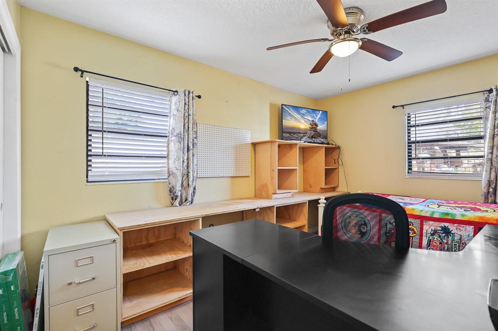 1001 Alpine Drive Brandon, FL 33510 - Photo 18 of 29 a bedroom with a bed and a chandelier