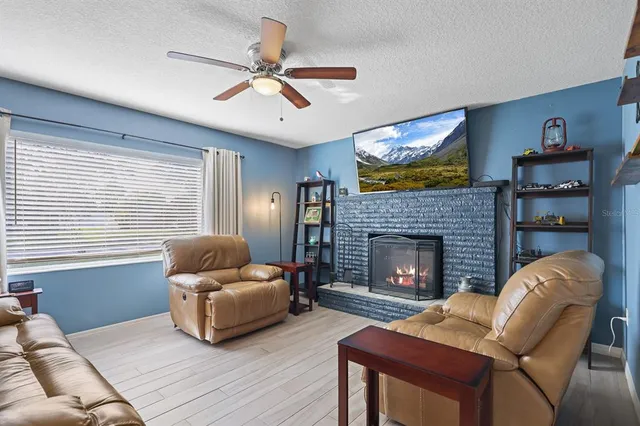 a living room with furniture and a fireplace