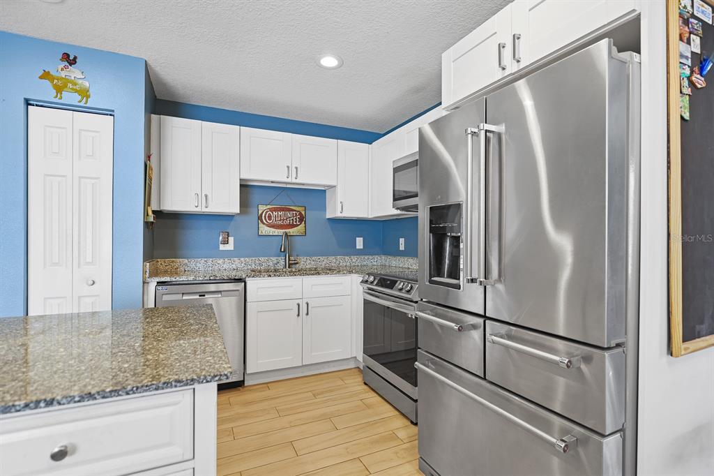 1001 Alpine Drive Brandon, FL 33510 - Photo 9 of 29 a kitchen with stainless steel appliances granite countertop a refrigerator sink and stove