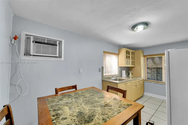 a living room with kitchen island furniture and a table