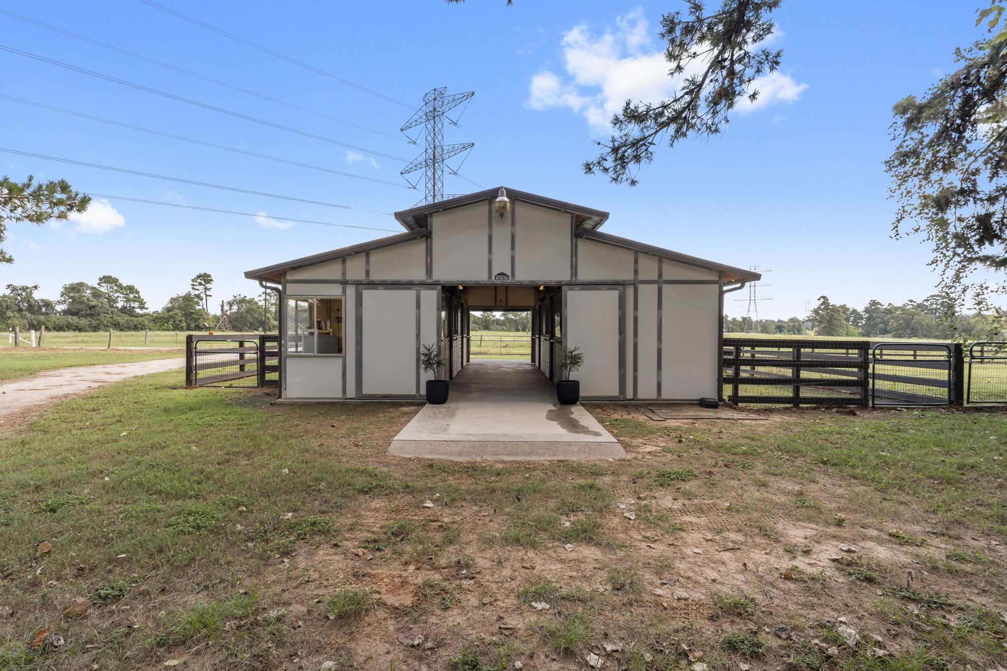 1534 Virgie Community Road Magnolia, TX 77354 - Photo 41 of 50 The four stall (matted 12'x10') MD/Barnmaster barn with concrete aisle sits perfectly behind the home for easy access. The front room to the left is the enclosed tack room with a enclosed feed room across the aisle. Plumber for automatic waterers. Walking through and to the back you will notice the wash rack ready to clean up the horses after a long ride. The runs on each side are a nice bonus to easily get horses outside for some sunshine. Surrounded by electrobraid fencing.