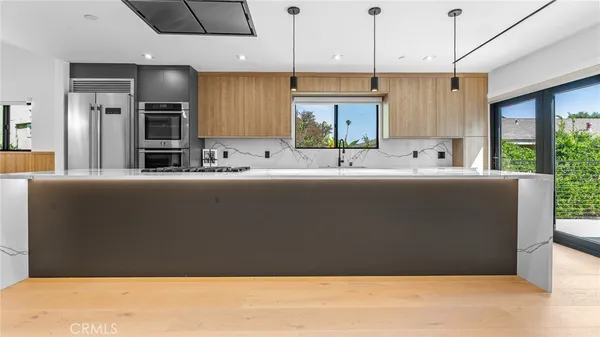 a large white kitchen with a large window