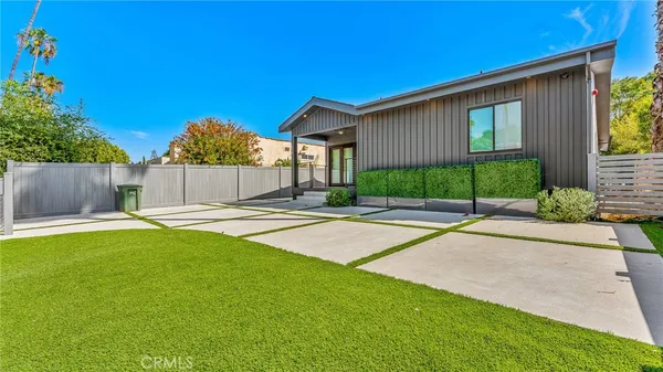 a view of a house with a yard and a garage