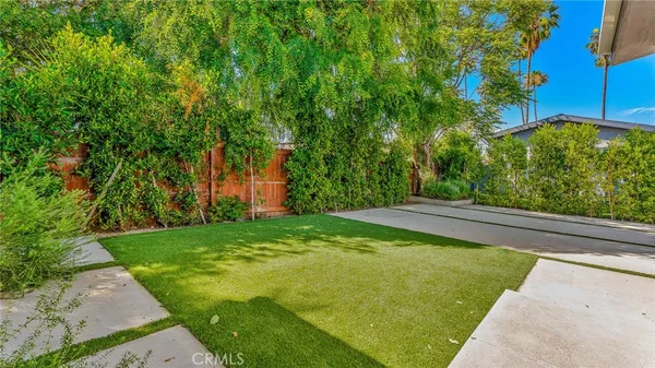 an aerial view of a house with garden space and street view